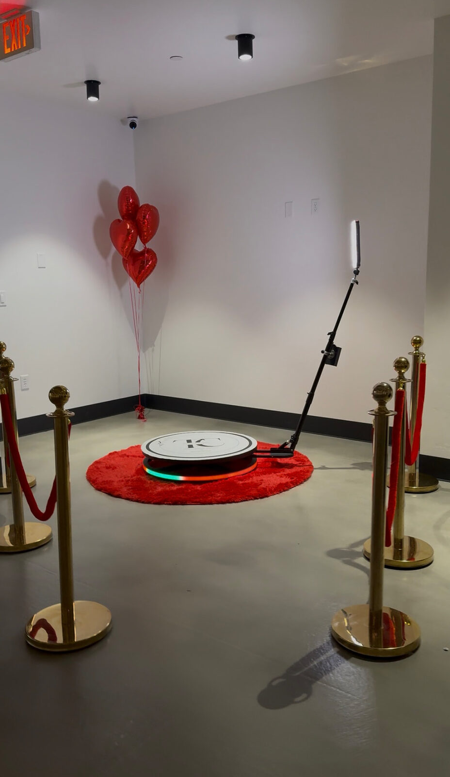360 video booth with red carpet and gold stanchions