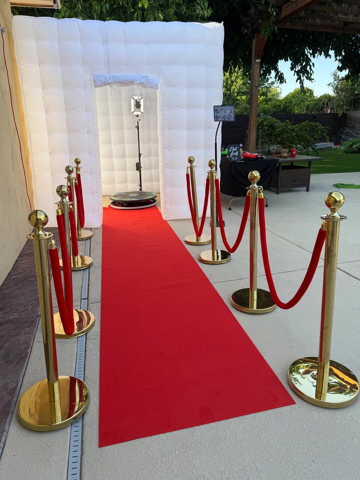 White luxury photo booth with red carpet entrance
